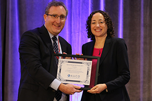 AUCD Executive Director Andy Imparato presents the award to Catherine Lhamon